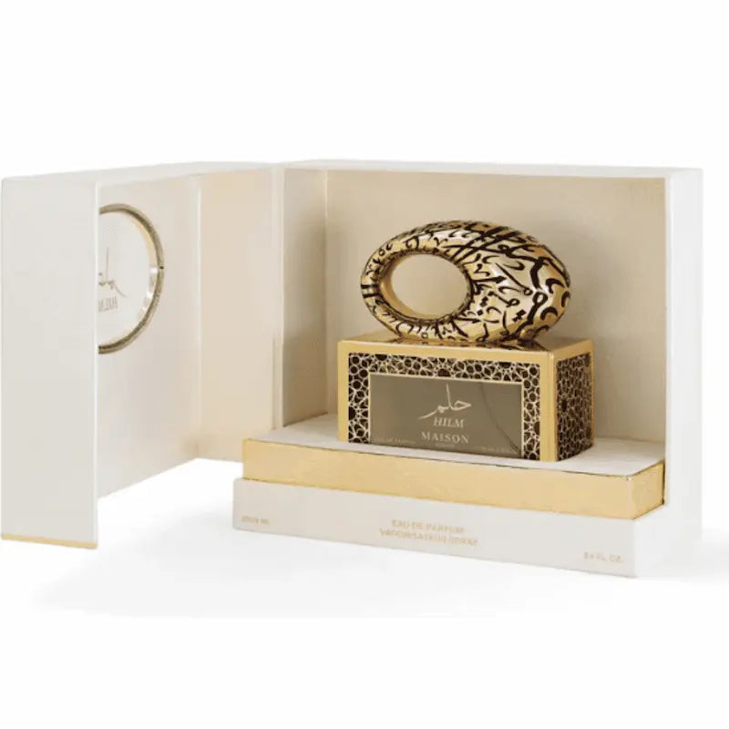 perfume Hilm de Maison Asrar en su caja original abierta con presentación de lujo en tonos dorados